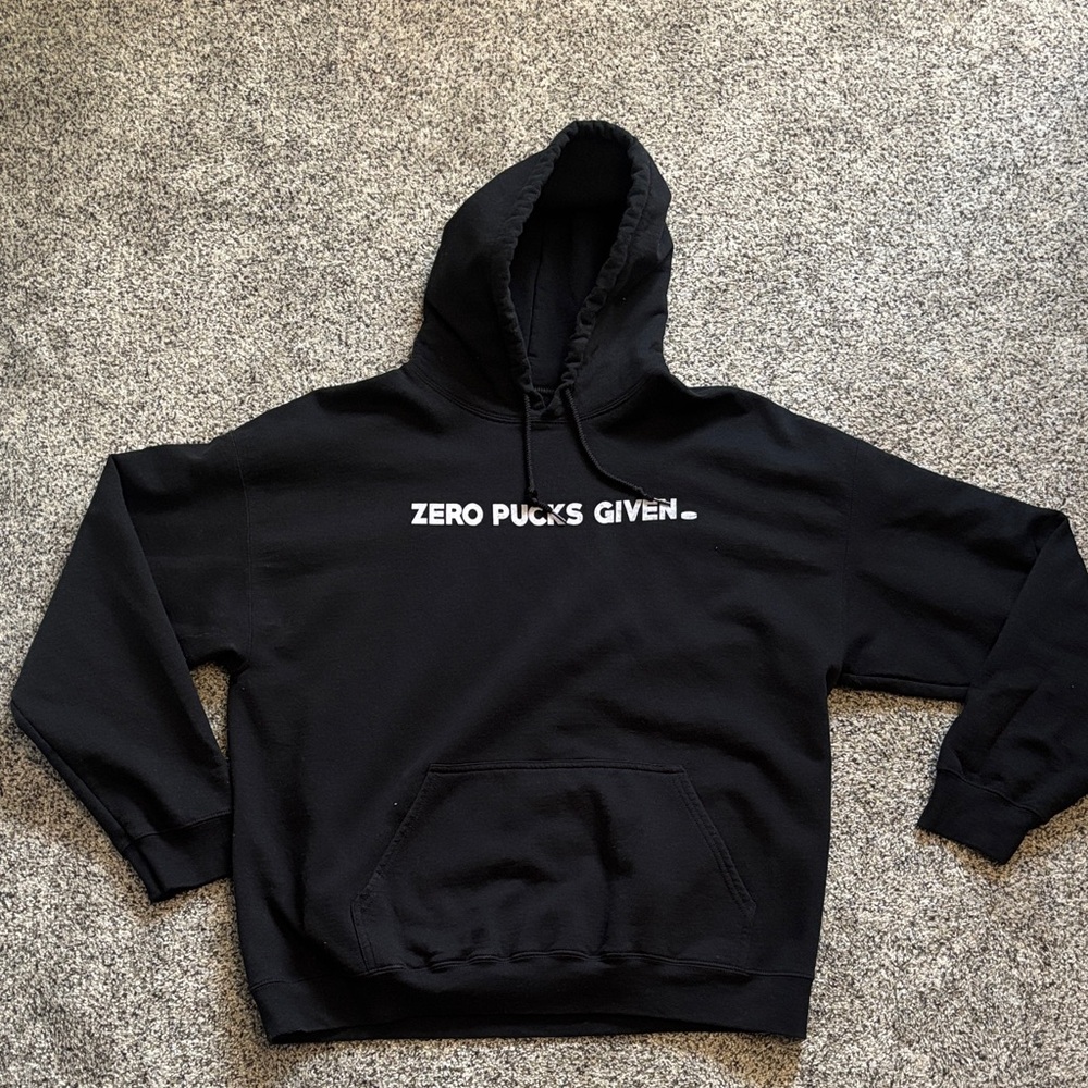 Black Hoodie with White "ZERO PUCKS GIVEN" Chest Graphic